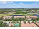 Overhead view of complex offers a pool, green spaces, parking, pond and golf course at 1003 Fairwaycove Ln # 103, Bradenton, FL 34212