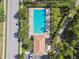 Aerial view of community pool with lounge area and landscaping, providing a resort-style experience at 1003 Fairwaycove Ln # 103, Bradenton, FL 34212
