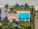 Overhead shot of a pristine community pool, surrounded by palm trees and seating, ideal for relaxation at 1003 Fairwaycove Ln # 103, Bradenton, FL 34212