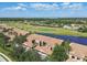 A picturesque aerial view of the community with manicured landscaping, lake, and ample parking at 1003 Fairwaycove Ln # 103, Bradenton, FL 34212