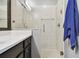 The bathroom shows a tiled shower with glass doors and a blue towel hanging from a bar at 1003 Fairwaycove Ln # 103, Bradenton, FL 34212