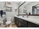 Stylish bathroom with dark wood vanity, quartz countertop, and decorative shelving; clean and modern at 1003 Fairwaycove Ln # 103, Bradenton, FL 34212