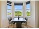 Charming breakfast nook features views of the tranquil pond through bay windows, great for morning coffee at 1003 Fairwaycove Ln # 103, Bradenton, FL 34212