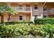 Inviting condo exterior featuring lush landscaping and neutral paint at 1003 Fairwaycove Ln # 103, Bradenton, FL 34212