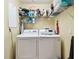 Efficient laundry room with modern washer and dryer, plus shelving for optimal storage solutions at 1003 Fairwaycove Ln # 103, Bradenton, FL 34212