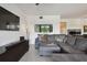 Comfortable living room with plush seating, a wall-mounted TV, and a view through an interior window at 1003 Fairwaycove Ln # 103, Bradenton, FL 34212