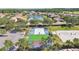 Community recreation area with shuffleboard and volleyball courts overlooking residential homes at 1003 Fairwaycove Ln # 103, Bradenton, FL 34212