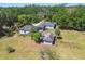 Overhead view of a cozy single-story home enveloped by mature trees and lush greenery at 101 N Taylor Rd, Seffner, FL 33584