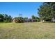 Spacious backyard featuring a screened pool enclosure and lush tropical landscaping, perfect for outdoor enjoyment at 101 N Taylor Rd, Seffner, FL 33584