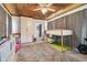 Cozy bedroom with wood-plank ceiling, bunk beds, and a colorful area rug at 101 N Taylor Rd, Seffner, FL 33584