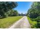 Long driveway leading to a charming home with a detached garage and mature landscaping at 101 N Taylor Rd, Seffner, FL 33584
