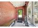 Enclosed entryway with textured walls, bench, and windowed door leading outside at 101 N Taylor Rd, Seffner, FL 33584
