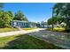 Exterior view of home with detached garage and spacious driveway at 101 N Taylor Rd, Seffner, FL 33584