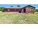 Exterior home view with arched entry way and well-maintained lawn at 101 N Taylor Rd, Seffner, FL 33584