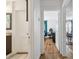 Hallway with wood floors leading to office and bathroom with dark wood accents at 101 N Taylor Rd, Seffner, FL 33584
