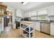 Bright kitchen featuring white cabinets, stainless steel appliances, and plenty of counter space at 101 N Taylor Rd, Seffner, FL 33584