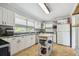 Bright kitchen featuring white cabinets, modern appliances, and plenty of counter space at 101 N Taylor Rd, Seffner, FL 33584