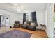 Cozy living room with hardwood floors, ceiling fan, and comfortable seating at 101 N Taylor Rd, Seffner, FL 33584