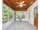 Light-filled sunroom boasts wood ceilings, white painted brick and tons of natural light at 101 N Taylor Rd, Seffner, FL 33584