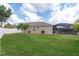 Large backyard featuring lush lawn, white fence, and screened-in lanai with a pool at 10911 Rockledge View Dr, Riverview, FL 33579