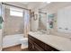 Well-lit bathroom with a bathtub and shower, framed mirror, toilet, and vanity with a white countertop at 10911 Rockledge View Dr, Riverview, FL 33579