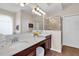 Bright bathroom with double sinks, granite countertops, framed mirror, and a walk-in shower at 10911 Rockledge View Dr, Riverview, FL 33579