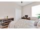 This bedroom features warm wood floors, a ceiling fan, and bright window at 10911 Rockledge View Dr, Riverview, FL 33579