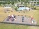 Aerial view of community park with playground, pool, tennis courts, and picnic areas at 10911 Rockledge View Dr, Riverview, FL 33579