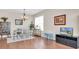 Bright dining room with wood floors, modern chandelier, and furniture at 10911 Rockledge View Dr, Riverview, FL 33579