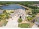 Aerial view of a charming single-story home with a lake view and mature landscaping at 10911 Rockledge View Dr, Riverview, FL 33579