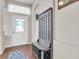 Inviting foyer with wood flooring, storage bench, and decorative door with sidelight at 10911 Rockledge View Dr, Riverview, FL 33579