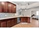 Open kitchen featuring wood floors, modern backsplash, stainless steel dishwasher, and a view into the bedroom at 10911 Rockledge View Dr, Riverview, FL 33579