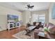 Comfortable living room with hardwood floors, ceiling fan, and sliding glass doors at 10911 Rockledge View Dr, Riverview, FL 33579