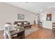 Open-concept living room flows into the kitchen, featuring hardwood floors and comfortable seating at 10911 Rockledge View Dr, Riverview, FL 33579