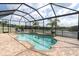 Screened-in pool with chairs overlooking lake on a sunny day at 10911 Rockledge View Dr, Riverview, FL 33579