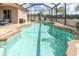 Relaxing screened-in pool with blue water, lounge chairs, and clear blue skies at 10911 Rockledge View Dr, Riverview, FL 33579