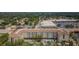 Aerial view of a multi-unit complex with a pool, landscaping, and shopping center nearby at 1216 S Missouri Ave # 108, Clearwater, FL 33756