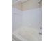 Bathroom with white tiled shower featuring a bathtub and chrome fixtures at 1216 S Missouri Ave # 108, Clearwater, FL 33756
