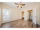 Primary bedroom with wood-look flooring and access to walk-in closet and en-suite bath at 1216 S Missouri Ave # 108, Clearwater, FL 33756