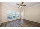 Bright bedroom with wood-look flooring and a large window offering ample natural light at 1216 S Missouri Ave # 108, Clearwater, FL 33756