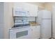 Cozy kitchen with white cabinets, granite countertops, and stainless steel microwave and oven at 1216 S Missouri Ave # 108, Clearwater, FL 33756