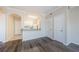 Bright, open-concept kitchen with white cabinets, granite countertops, and modern appliances adjacent to the living area at 1216 S Missouri Ave # 108, Clearwater, FL 33756