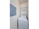 A laundry room with a white washing machine and shelving at 1216 S Missouri Ave # 108, Clearwater, FL 33756