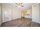 Spacious living room featuring wood-look flooring and an open layout to the kitchen at 1216 S Missouri Ave # 108, Clearwater, FL 33756