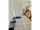 Functional entryway features tile flooring and white door next to stainless steel refrigerator at 12315 Touchton Dr # 90, Tampa, FL 33617