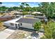 Aerial view of the property with landscaping and driveway at 1235 Stockton Dr, Clearwater, FL 33755