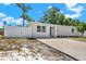 Charming single-story home with white siding, a well-maintained front yard, and a concrete driveway at 1235 Stockton Dr, Clearwater, FL 33755