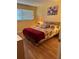 Comfortable bedroom with a floral-themed bedding, a painting, and warm lighting at 1301 S Hercules Ave # 19, Clearwater, FL 33764