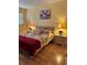 Cozy bedroom featuring two nightstands, floral bedding, and a decorative painting at 1301 S Hercules Ave # 19, Clearwater, FL 33764