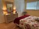Bedroom with coordinated bedding, dresser with mirror, and window with blinds at 1301 S Hercules Ave # 19, Clearwater, FL 33764